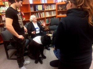 students interacting with dog