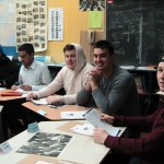 students sitting around a map of the world