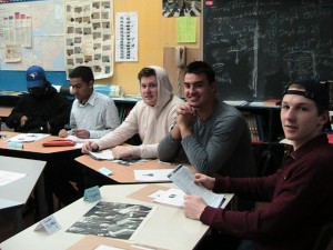 students sitting around a map of the world