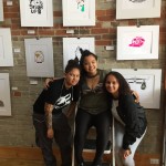 students smiling in front of pics