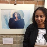f posing in front of a picture of herself
